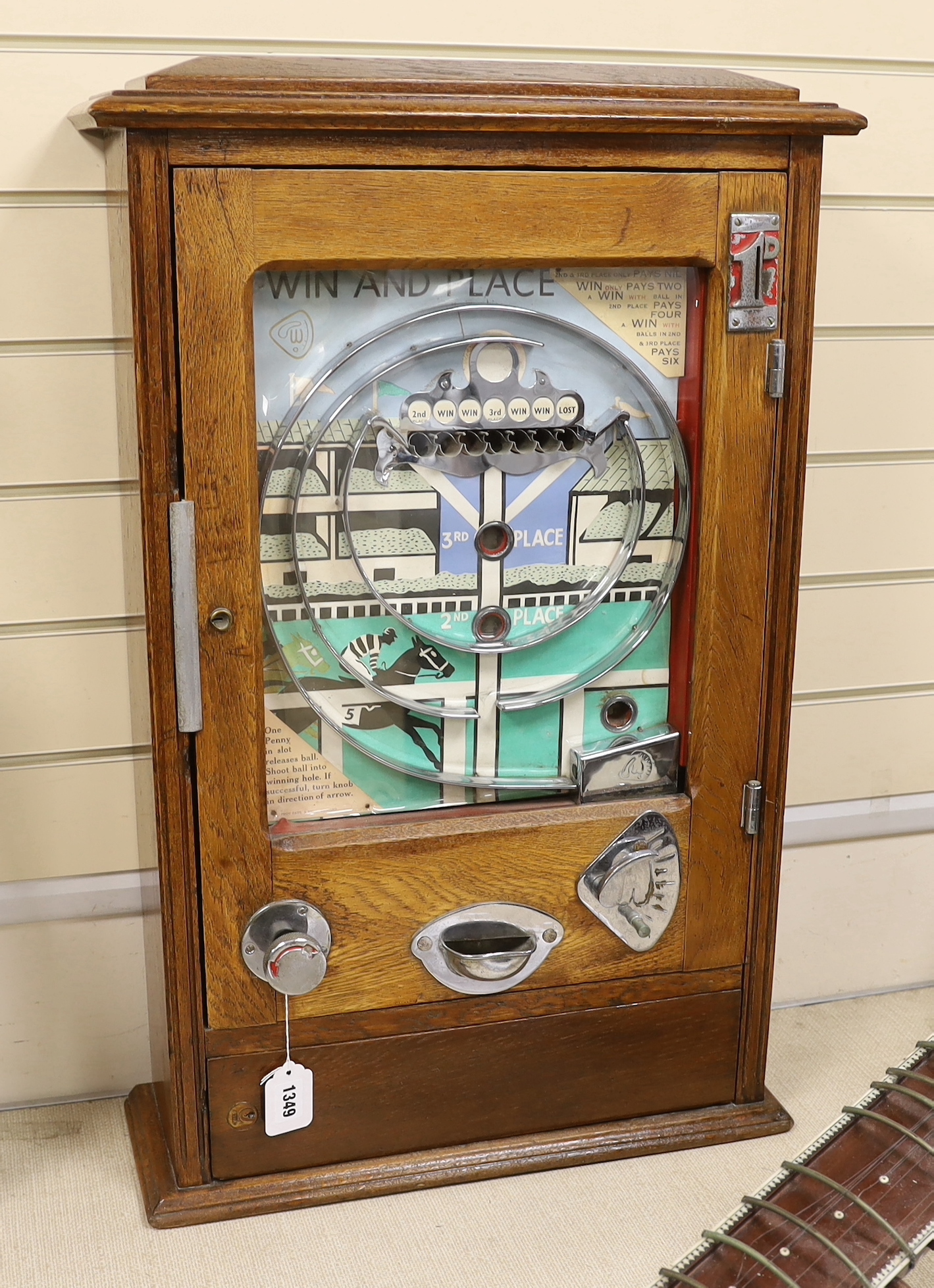 A 1950s Wondermatics Allwin penny slot machine, 'Win and Place' pin ball machine in oak case, 79 x 50cm